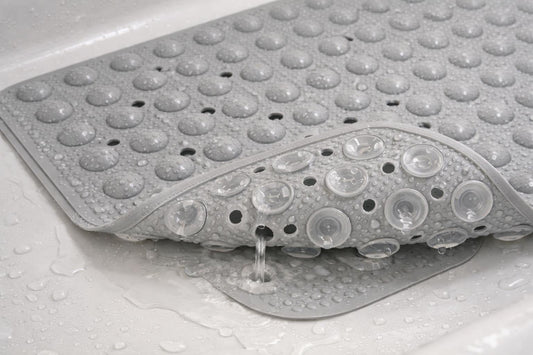 textured bathtub mat in tub showing suction cups and drainage